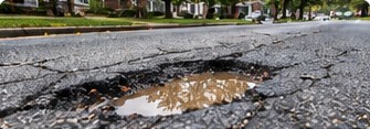 Pothole and damaged asphalt on a road